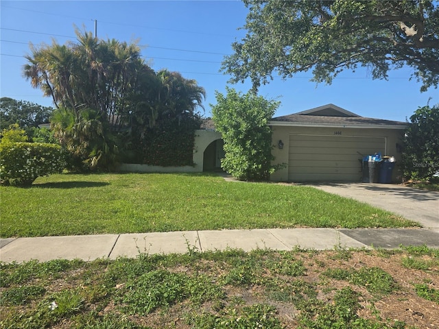 view of yard with concrete driveway and a garage