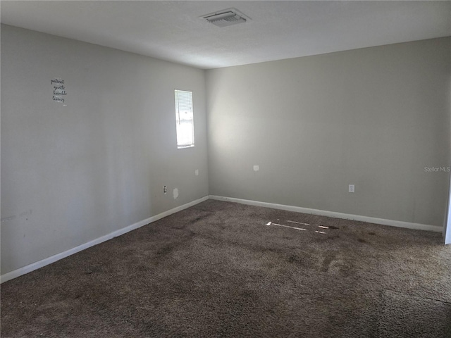 carpeted empty room with baseboards and visible vents