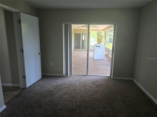 spare room with carpet, baseboards, and washer / dryer