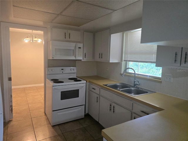 kitchen featuring a sink, light tile patterned flooring, white appliances, and backsplash