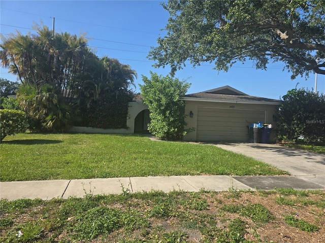 view of yard featuring an attached garage and driveway