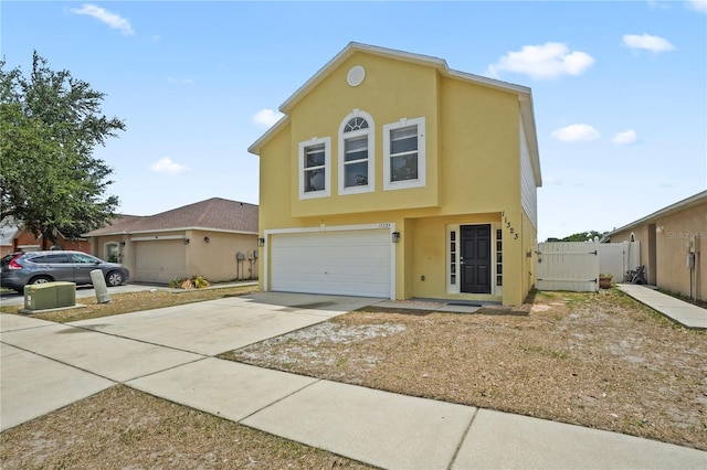 11323 Ivy Flower Loop, Riverview, FL 33578 - view of front of house with a gate, fence, driveway, a garage, and stucco siding