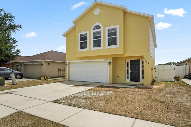 11323 Ivy Flower Loop, Riverview, FL 33578 - view of front of home with an attached garage, concrete driveway, stucco siding, and fence