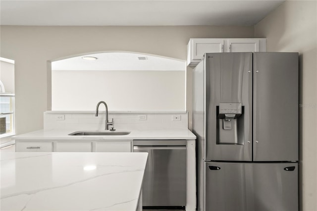 11323 Ivy Flower Loop, Riverview, FL 33578 - kitchen with a sink, stainless steel appliances, white cabinets, light stone countertops, and tasteful backsplash