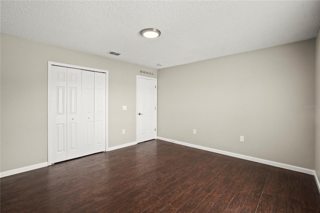 11323 Ivy Flower Loop, Riverview, FL 33578 - unfurnished bedroom featuring dark wood finished floors, visible vents, and baseboards