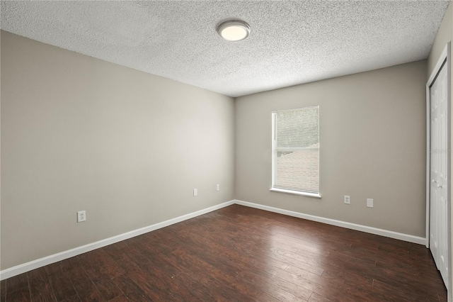 11323 Ivy Flower Loop, Riverview, FL 33578 - unfurnished room with baseboards, dark wood-style flooring, and a textured ceiling