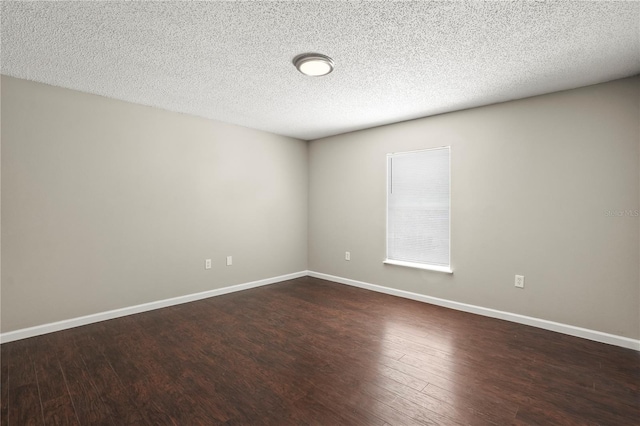 11323 Ivy Flower Loop, Riverview, FL 33578 - spare room with a textured ceiling, dark wood-type flooring, and baseboards