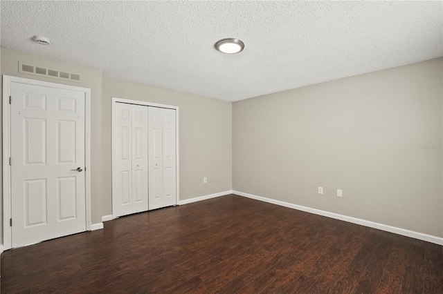 11323 Ivy Flower Loop, Riverview, FL 33578 - unfurnished bedroom with visible vents, baseboards, and dark wood-type flooring