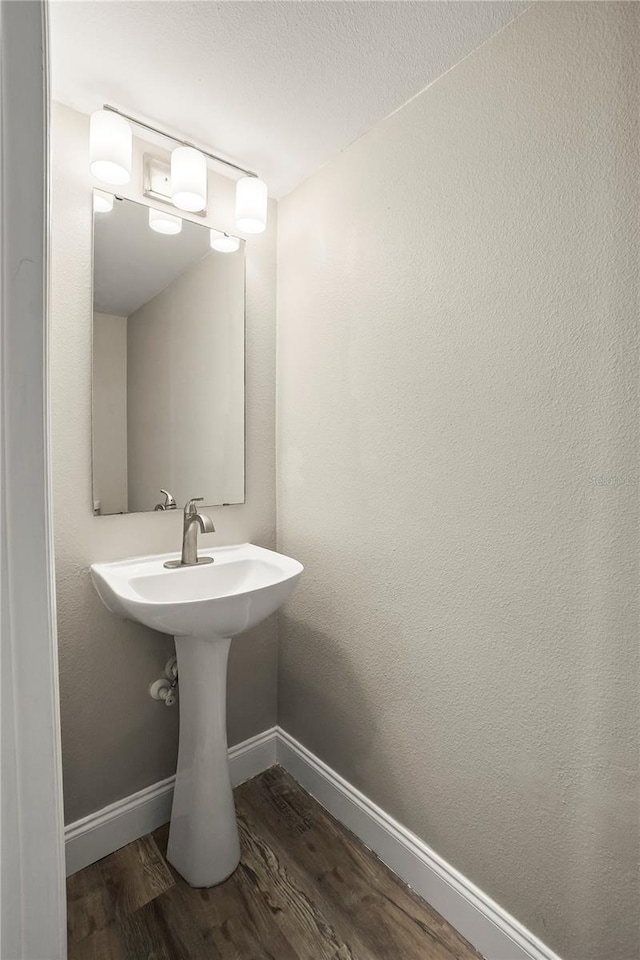 11323 Ivy Flower Loop, Riverview, FL 33578 - bathroom featuring baseboards and wood finished floors