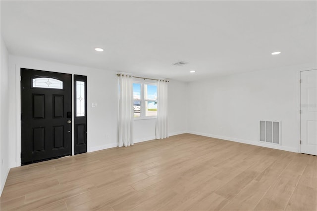 13612 Veronica Dr, Hudson, FL 34667 - foyer entrance featuring light wood finished floors, recessed lighting, and baseboards