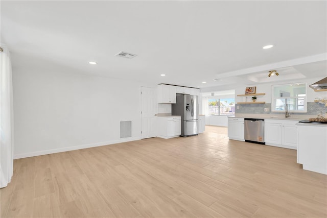 13612 Veronica Dr, Hudson, FL 34667 - kitchen featuring appliances with stainless steel finishes, open shelves, white cabinets, light wood-style floors, and recessed lighting