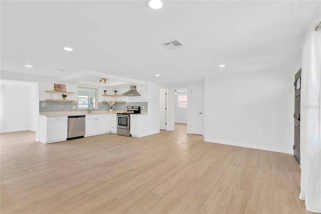 13612 Veronica Dr, Hudson, FL 34667 - unfurnished living room with baseboards, recessed lighting, and light wood-style flooring