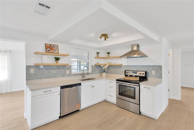 13612 Veronica Dr, Hudson, FL 34667 - kitchen featuring appliances with stainless steel finishes, open shelves, a sink, wall chimney range hood, and light countertops