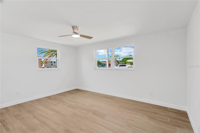 13612 Veronica Dr, Hudson, FL 34667 - empty room with light wood-style flooring, ceiling fan, and baseboards