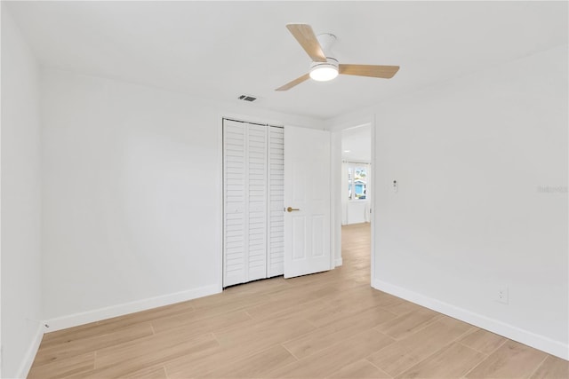 13612 Veronica Dr, Hudson, FL 34667 - unfurnished bedroom featuring baseboards, light wood finished floors, a closet, and ceiling fan