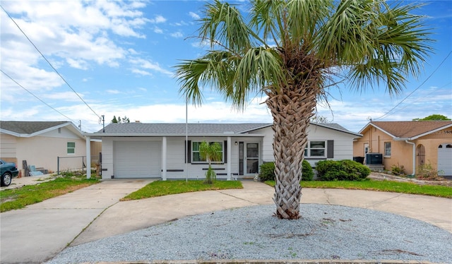13612 Veronica Dr, Hudson, FL 34667 - ranch-style home with curved driveway, an attached garage, and cooling unit