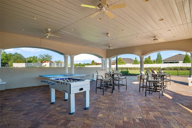 view of patio featuring a ceiling fan, fence, and outdoor dining space