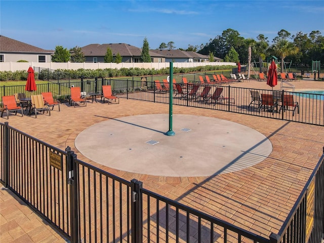 surrounding community with fence and a patio