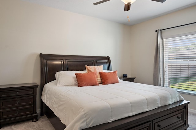 bedroom with light carpet, baseboards, and a ceiling fan