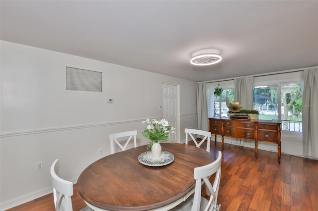 dining space featuring baseboards, visible vents, and wood finished floors