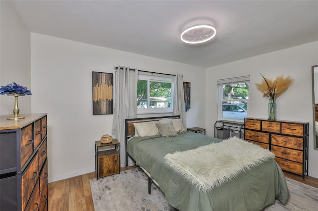 bedroom featuring light wood-type flooring and baseboards