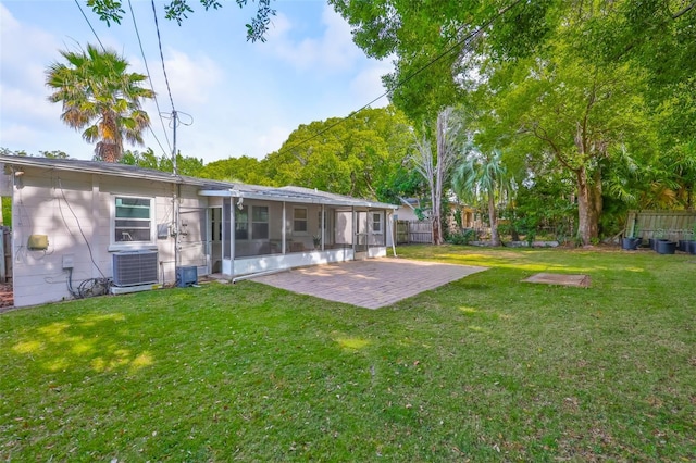 view of yard with a patio area, a sunroom, cooling unit, and fence