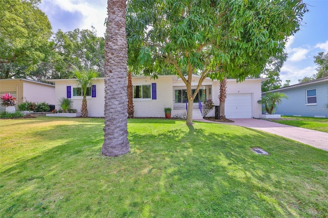 view of front of home with an attached garage, a front yard, and driveway