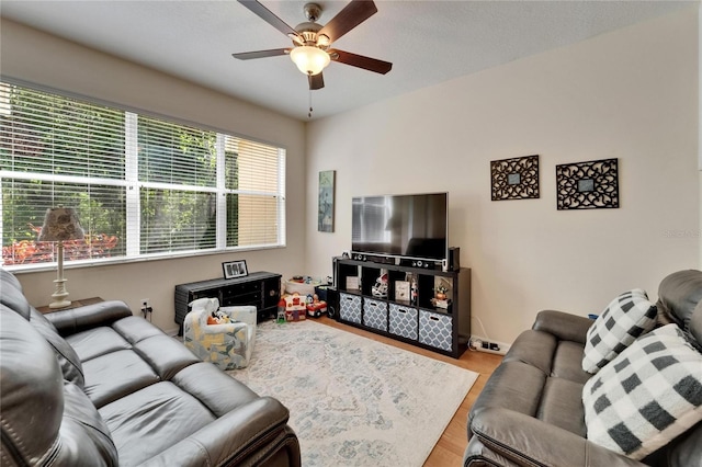 living area with ceiling fan and wood finished floors