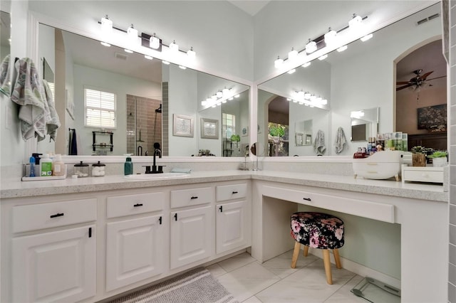 bathroom featuring a stall shower, ceiling fan, visible vents, and vanity