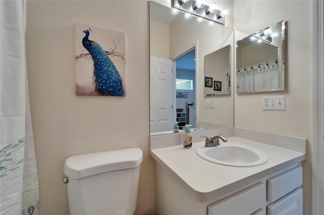 bathroom featuring toilet and vanity