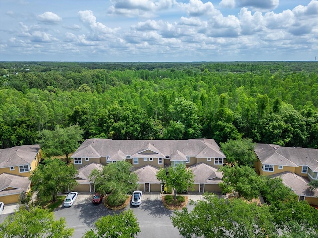 birds eye view of property featuring a wooded view and a residential view