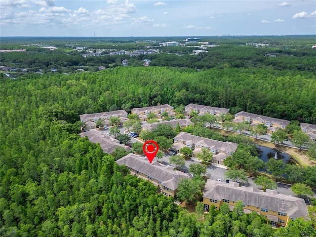 birds eye view of property with a forest view and a residential view