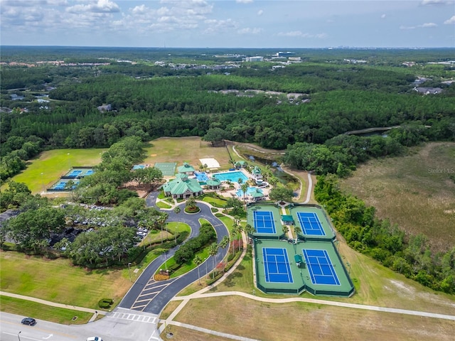 bird's eye view with a wooded view