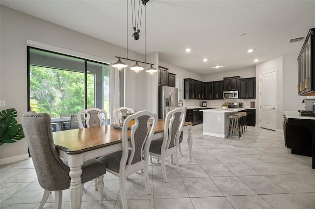 dining space with recessed lighting, light tile patterned flooring, and baseboards