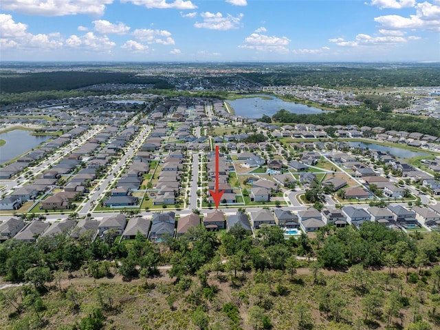 aerial overview of property's location featuring nearby suburban area and a nearby body of water