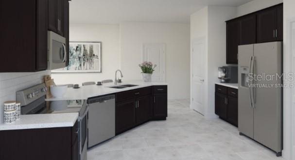 2115 Forage Dr, Kissimmee, FL 34746 - kitchen with light countertops, stainless steel appliances, and a sink