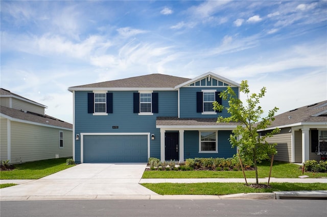 2115 Forage Dr, Kissimmee, FL 34746 - view of front facade featuring a front lawn, driveway, a shingled roof, and a garage