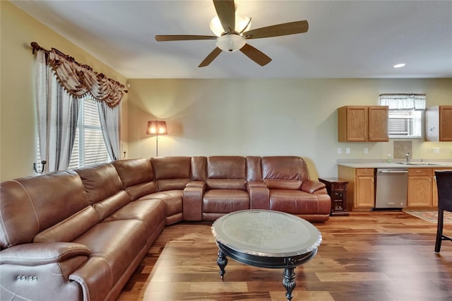 living area featuring ceiling fan, light wood-type flooring, a healthy amount of sunlight, and recessed lighting
