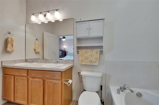 bathroom with a sink, toilet, a garden tub, and a ceiling fan