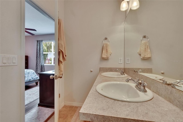 bathroom with double vanity, connected bathroom, and a sink