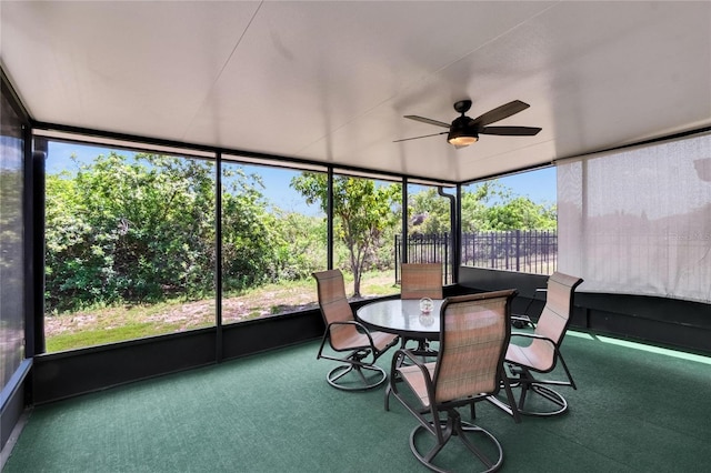 sunroom with outdoor dining area and ceiling fan