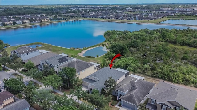 birds eye view of property with a water view and a residential view