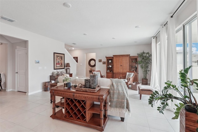living room featuring light tile patterned floors and baseboards
