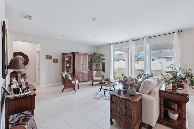 living area featuring light tile patterned floors and baseboards