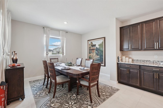 dining space with light tile patterned flooring, recessed lighting, and baseboards