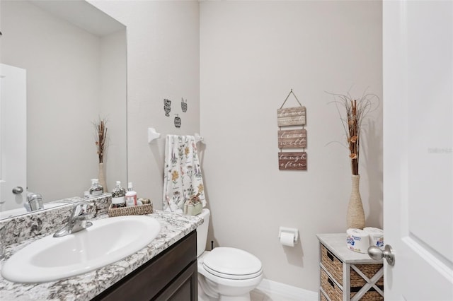 bathroom featuring toilet and vanity