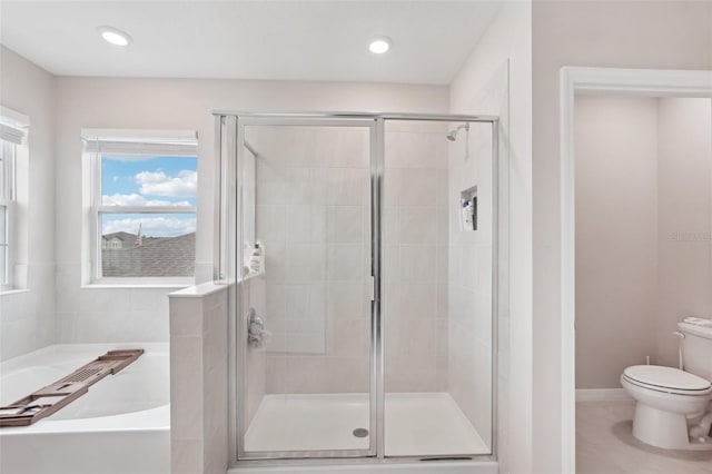 bathroom with a bath, toilet, and a shower stall