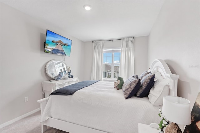 carpeted bedroom featuring baseboards