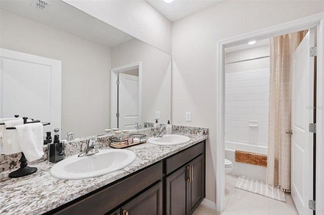 bathroom featuring toilet, double vanity, shower / bathtub combination with curtain, and tile patterned floors