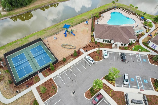 drone / aerial view of a large body of water and a pool area